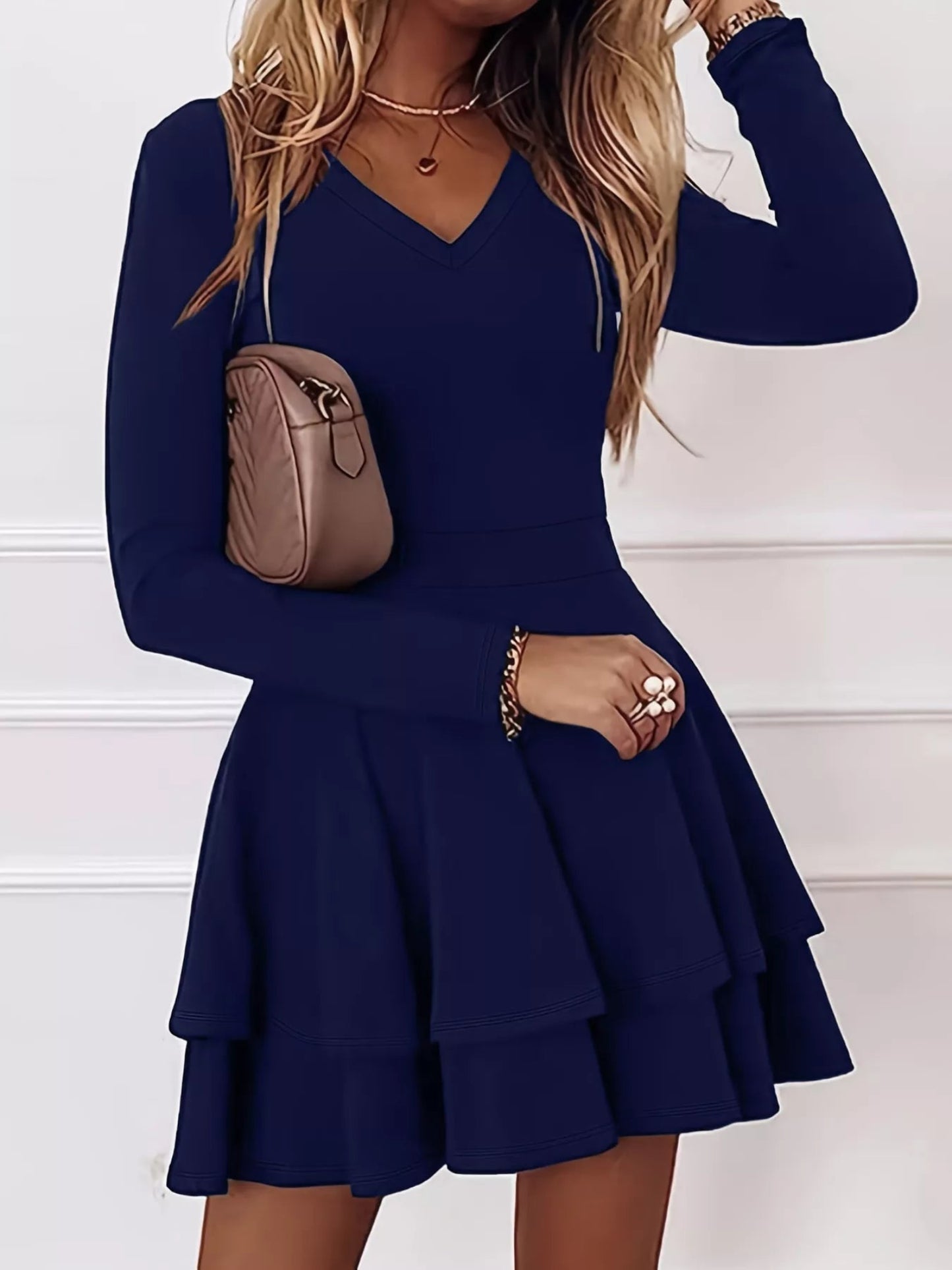 Woman wearing a navy blue dress with long sleeves