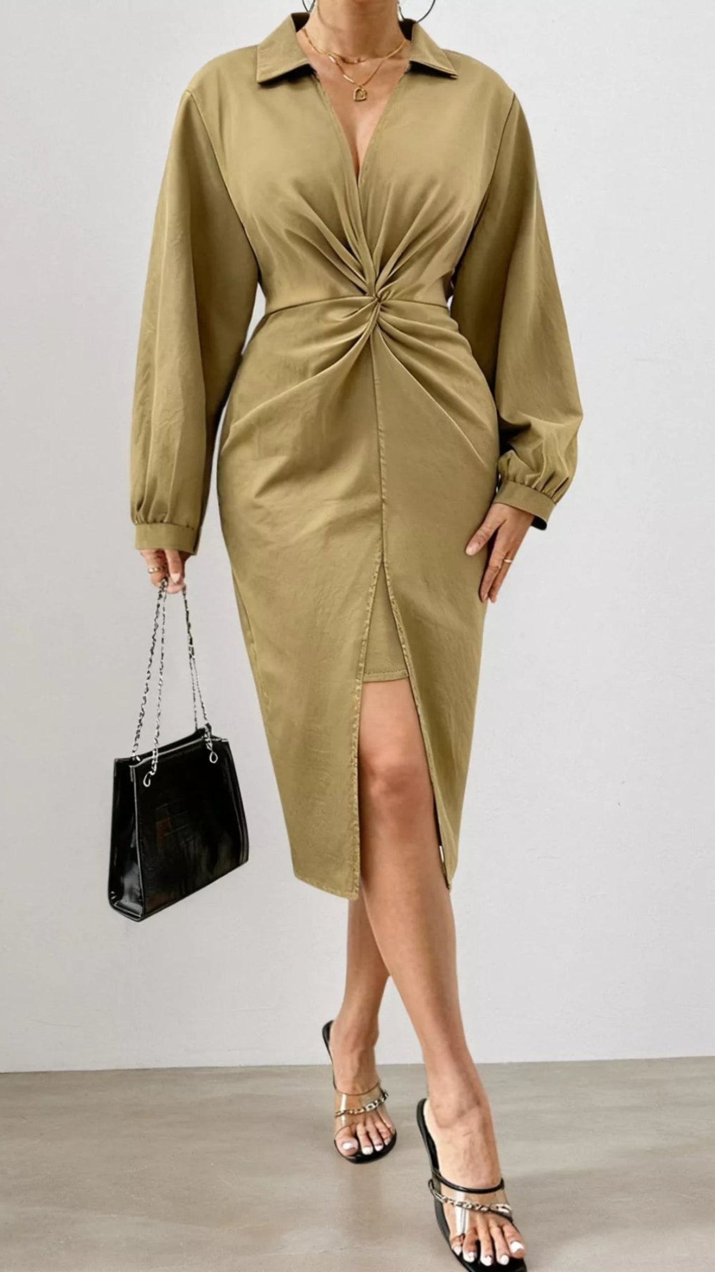 Woman wearing a green dress with a plain background